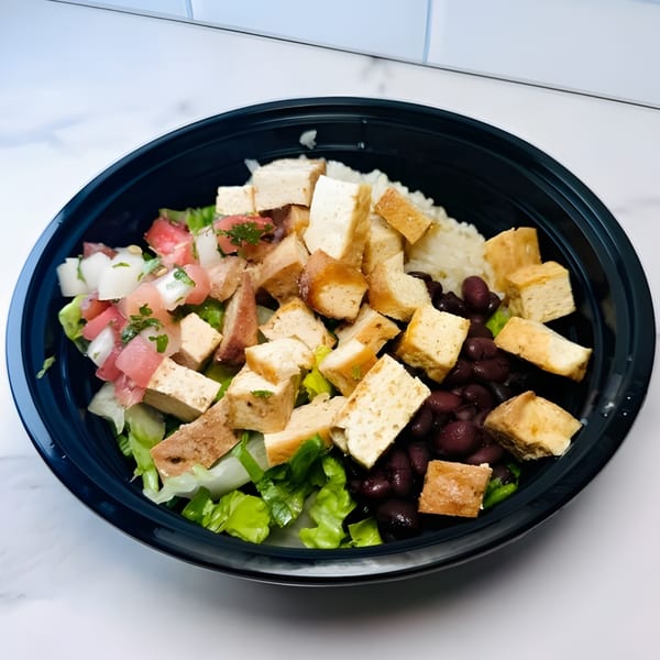 A 360 Gourmet Burritos bowl with tofu, black beans, rice, lettuce, and pico de gallo.
